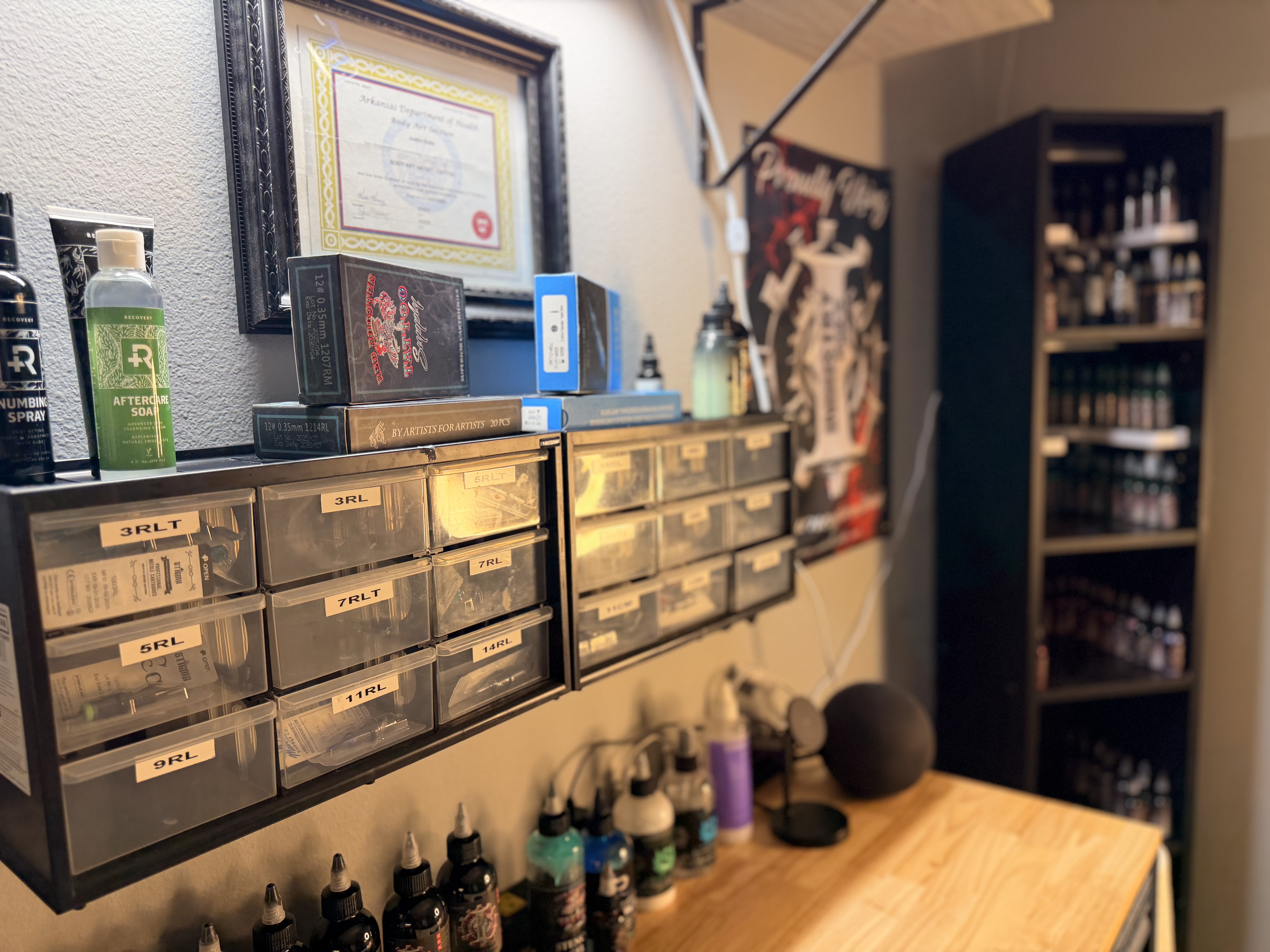 Art gallery hallway at Apex Tattoo Conway featuring framed prints